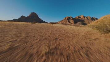 Mountains in sandy desert view from FPV drone video
