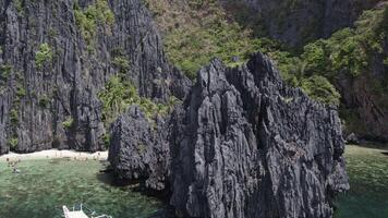 cliffs in Lagoon on the islands, Palawan, boats Philippines. Drone view video
