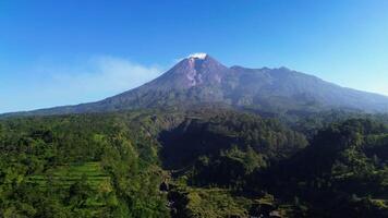 4k landscape of active volcano in detail with green forest in front. Panoramic aerial drone footage of Mount Merapi from a short distance with a beautiful view on a summer morning video
