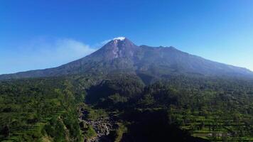 4k landscape of active volcano in detail with green forest in front. Panoramic aerial drone footage of Mount Merapi from a short distance with a beautiful view on a summer morning video