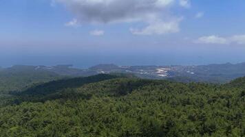 Drone Flying Over Mountain Forest with Sea and Clouds in Background video