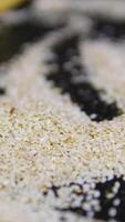 fry sesame White sesame in the process of roasting to make into snack. video