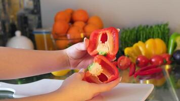 Women's hands hold and twist in different directions a large red bell pepper near the store counter. Choose peppers for the kitchen, lunch. Vegetables in the diet, healthy eating. video