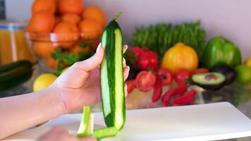 peel a cucumber Hands using a peeler to remove the skin from a fresh cucumber on a wooden board video
