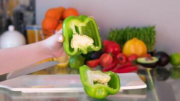 hands chopping green fresh pepper on a cutting board then throws peppers with a knife. Fast. video