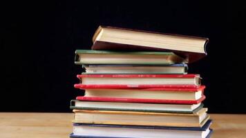 Stack of Books Toppling in Slow Motion for Dramatic Effect video