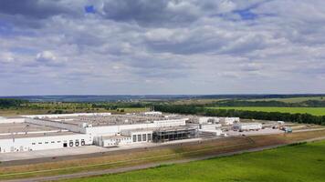 Kyiv, Ukraine, 29 May 2024 A modern factory in the process of building. Aerial view of stylized altered generic modern industrial building. video