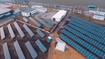 Solar batteries on the ground near factory or plant. Addicional sourse of green energy. from the top. video
