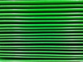the layer of green vibrant plates color makes a stripped surface horizontal lines photo