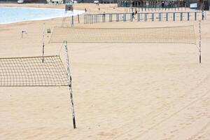 Volleyball net on a sand beach by the sea photo