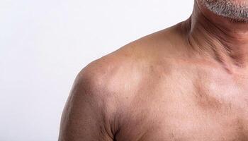 detailed view of wrinkled skin around the collarbone and shoulder area with visible folds and age-related texture in isolated white background photo