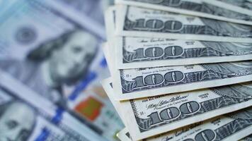 Edges of hundred dollar bills spinning around. Paper money background. American banknotes rotating on dollars background. video