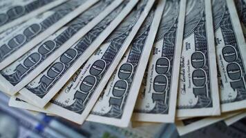 Hundred dollar bills are spinning on a table. Background of american money with one hundred banknotes. Rotation of paper money. Close-up. video