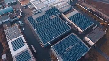 Top view of solar power station on roofs. View from the air on the buildings with blue solar panels. Renewable source of energy from the sun. Aerial view. video