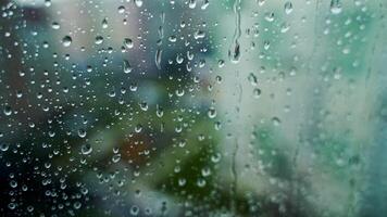 Rain drop on glass window on blur city view background. Raining weather. Water drops background. Close-up. video