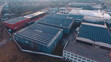 Top view of solar farm on the industrial buildings. Photovoltaic solar panels on roofs at sunset. New source of ecological energy. Aerial view. video