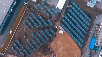 Solar farm on the field. Photovoltaic panels to receive clean alternative energy from the sun. Aerial view. Motion camera around. video