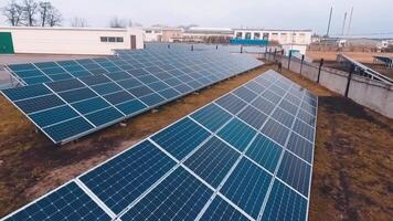 Solar panels farm on the field. Drone flight over huge blue solar panels at sunlight. Renewable green alternative energy. Slow motion. video