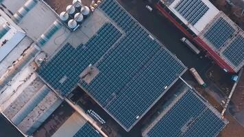 Modern solar station on roofs of industrial buildings. Photovoltaic cells for getting ecological energy from the sun. Camera moves round. Aerial view. video