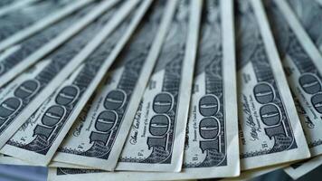 Rich background of one hundred dollars. American money rotating slowly. A lot of paper banknotes of dollar bills spinning. Close-up. video