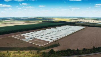 Industrial complex on nature background. View from the air on a modern factory among fields. Aerial view. video