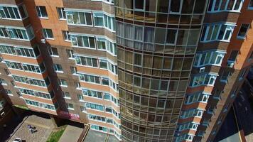 Modern skyscraper in the city center. New block of flats in the residential area. Exterior of high-rise architecture with balconies and windows. video