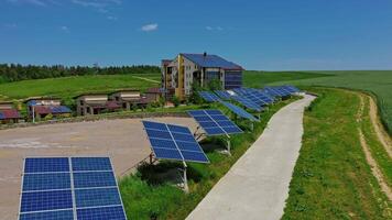 Building with solar panels in nature. Blue sunny batteries along the road. Photovoltaic cells generate ecological energy at sunlight in summer. video