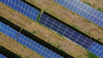 Photovoltaic panels at sunlight. Long blue solar panels on the field collect clean energy from the sun. Sustainable source of energy. Top view. video