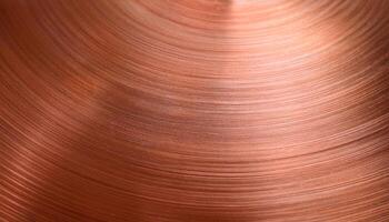 close-up of a polished copper surface with circular brushed texture and reflective highlights photo