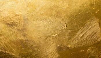 close-up of textured gold leaf surface with bold brushstroke patterns and radiant metallic finish for luxury backgrounds photo