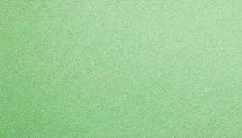macro view of pale green paper with faintly visible grain texture, ideal for eco-friendly crafts, stationery, and artistic projects photo