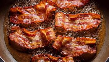 top view of crispy bacon slices frying in hot oil with bubbling textures and golden edges curling in a frying pan photo
