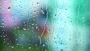 Water flowing down on a glass window. Raindrops on window pane. Rainy weather. Background of rain. Close-up. video