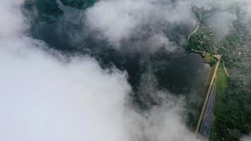 Amazing view from the sky. Flight among clouds on water background near the countryside. Aerial view. video