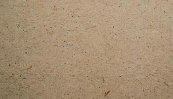 close-up of recycled paper texture with uneven surface and visible speckled patterns in natural beige tones photo