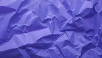 close-up of crumpled violet paper texture with intricate folds and wrinkles for creative backgrounds photo