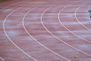 Running track covered with first snow of winter photo