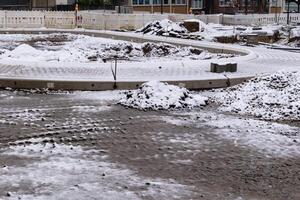 Road construction site covered with snow during winter photo