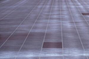 Empty parking lot showing white lines and one dark spot photo