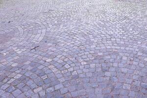 Cobblestone pavement forming concentric arcs in urban setting photo