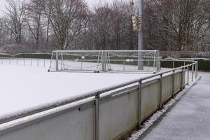 Soccer field covered with snow in winter photo