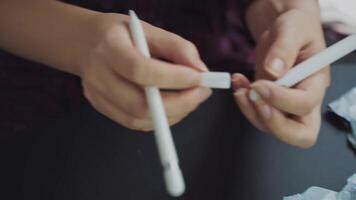 Unpacking and demonstrating the quality of a new gadget accessory. Women's hands take out a white rubber case for an electronic stylus from the package. Online shopping services. video