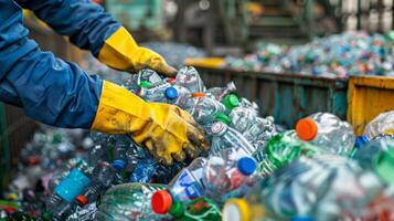 Workers in protective gloves sort through a large collection of plastic bottles at a recycling facility, ensuring proper waste management. photo