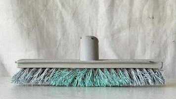 Cleaning tool with soft bristles on a plain background in a work environment photo