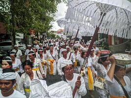 Bali - July 4, 2024. Ngangget Don Bingin is one of the sequences in the Memukur ceremony, an important ritual in Balinese tradition aimed at honoring and praying for the ancestral spirits photo