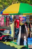 Kupang - October 12, 2024. A Man passing by notices woven fabric with East Nusa Tenggara motifs displayed for sale in the car-free day area photo