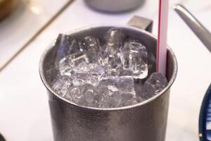 Glass with ice cubes and straw. Close up and Top view photo