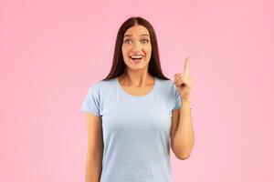 Great Idea Concept. Young Funny Woman Pointing Finger Up. Excited Lady Knows Answer, Got Solution To Problem, Having Aha Moment Or Inspiration, Isolated On Yellow Studio Background. Wow, Eureka photo