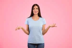 Who Knows. Portrait Of Confused Woman Shrugging Shoulders, Spreading Hands, Looking At Camera Posing Over Yellow Background. Studio Shot. Puzzled lady is clueless. I'm sorry, exuse me, can't decide photo