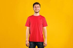 Portrait of handsome bearded man smiling, looking and posing at camera isolated over blue studio background. Confident caucasian guy with happy facial expression showing positive emotions photo
